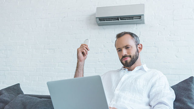 man using air conditioner at home.jpg